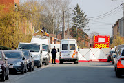 A police officer looks on at the site where a vehicle drove into a group of Belgian carnival performers who were preparing for a parade in the village of Strepy-Bracquegnies, Belgium March 20, 2022.