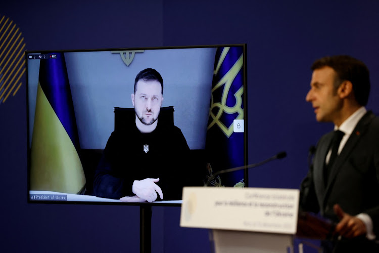 Ukrainian President Volodymyr Zelensky listens via video link as French President Emmanuel Macron delivers a speech in Paris, France, December 13 2022. Picture: LUDOVIC MARIN/REUTERS