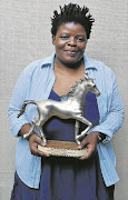 Writer and director of The Bycicle Man  Ntombozuko   Twiggy   Matiwana  holding the Silver Stallion Prize. Pic. © Supplied