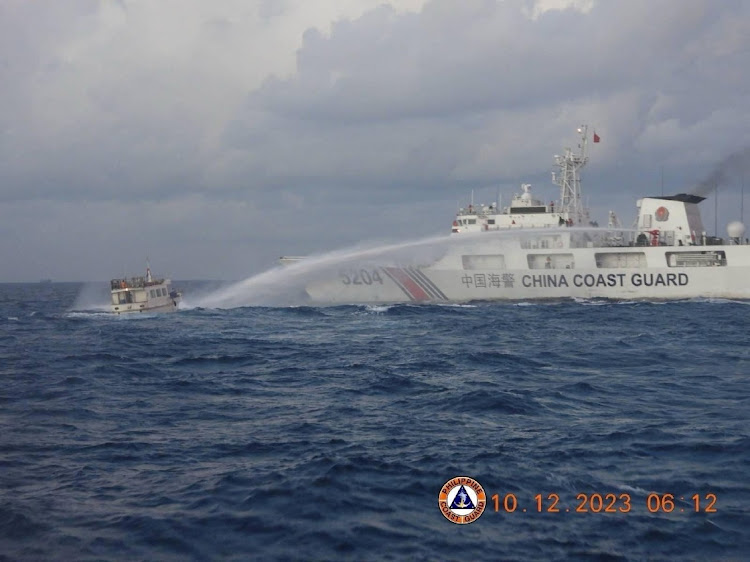 A Chinese Coast Guard ship uses a water cannon against a Philippines resupply vessel heading towards the disputed Second Thomas Shoal, in the South China Sea, December 10 2023. Picture: PHILIPPINE COAST GUARD/REUTERS