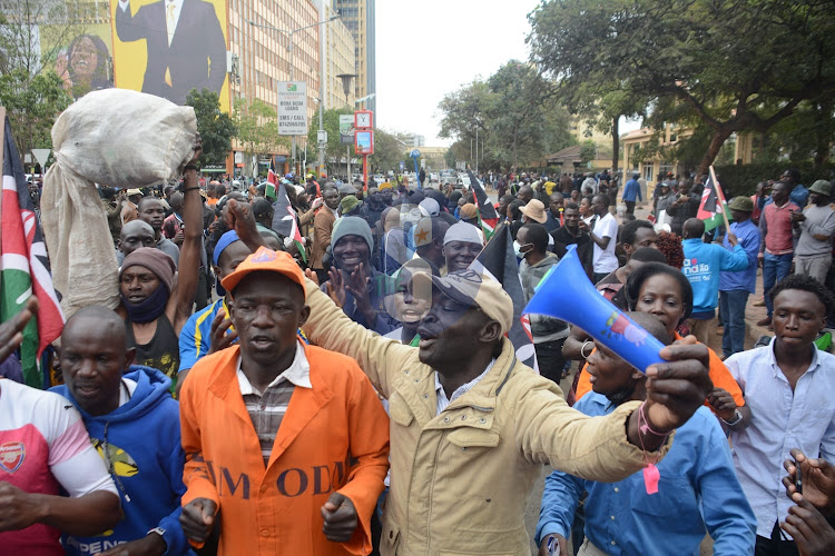 Azimio supporters celebrate outside KICC in Nairobi during the inaugural meeting of elected members at KICC on Saturday, August 13