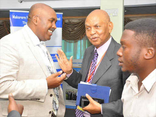 Mount Kenya university Chairman and Founder. prof. Simon Gicharu {left} with Makerere University Immediate past Chancellor prof. George Kagonyera , Gesture after Invitation by Makerere University Business School during 8th Annual International Leadership conference at Entebbe Uganda ,