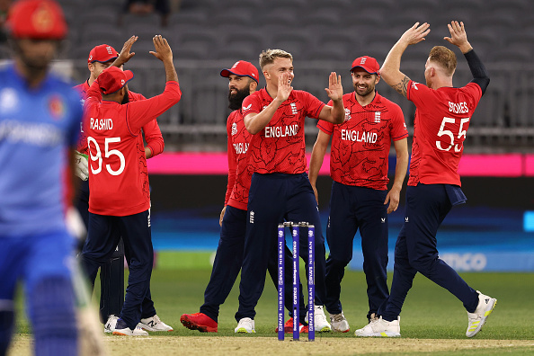 England bowler Sam Curran celebrates with teammates after dismissing Fazalhaq Farooqi of Afghanistan and claiming his 5th wicket during the ICC Men's T20 World Cup at Perth Stadium on October 22 in Australia.