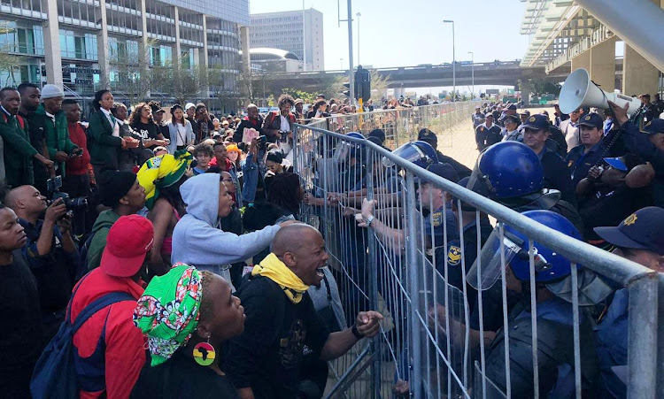 Police struggle to hold back protesters who besieged the World Economic Forum at Cape Town International Convention Centre on September 4 2019.