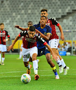 Houari Baouche of USM Alger tackled by Taahir Goedeman of Cape Town City FC during the CAF Confederation Cup, play-offs leg 1 match between Cape Town City FC and USM Alger at DHL Stadium.