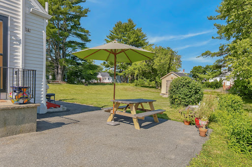 Picnic table with umbrella on patio in this luxury house for sale in Portland ($505,000)