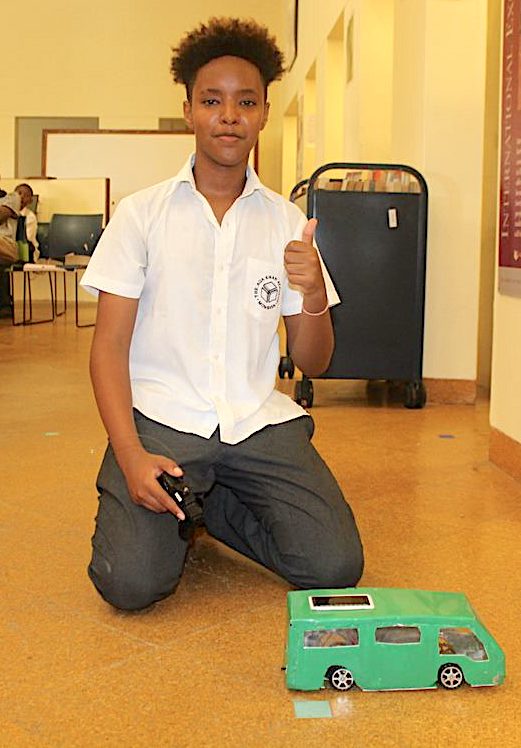 Mohamed Abdi with her Soar and electric matatu model