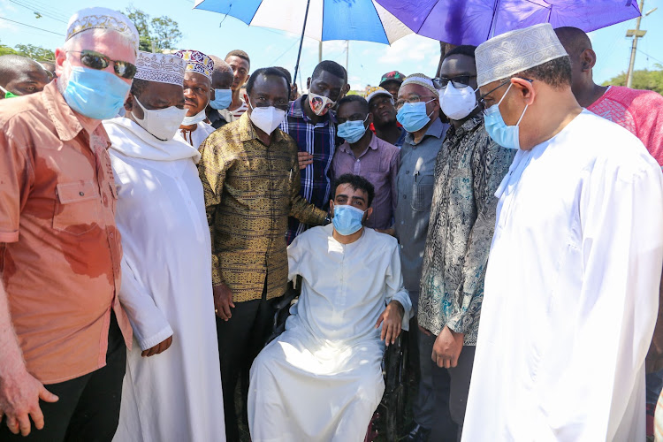 Wiper leader Kalonzo Musyoka consoles the late Salim Bajaber's son Ali Salim Bajaber at the Kiziwi cemetery in Mombasa on Monday.