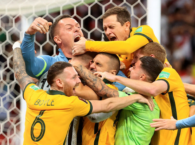 Australia's Andrew Redmayne and teammates celebrate after qualifying for the FIFA World Cup at Al Rayyan Stadium, Al Rayyan, Qatar on June 13, 2022