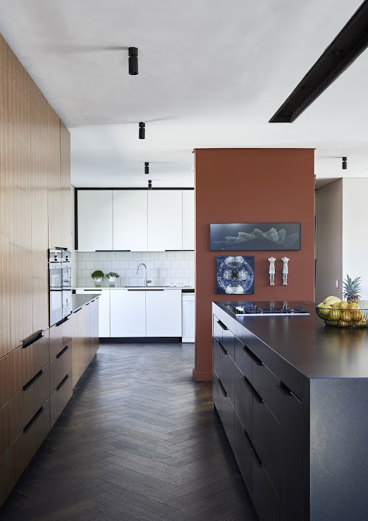 The kitchen includes two sections – one part hidden behind a terracotta wall.