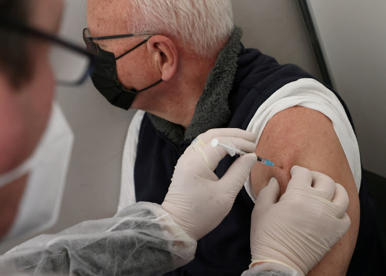 A doctor vaccinates a man with Comirnaty Pfizer-BioNTech Covid-19 vaccine at a vaccination centrel in Berlin, Germany, November 22 2021. Picture: FABRIZIO BENSCH/REUTERS