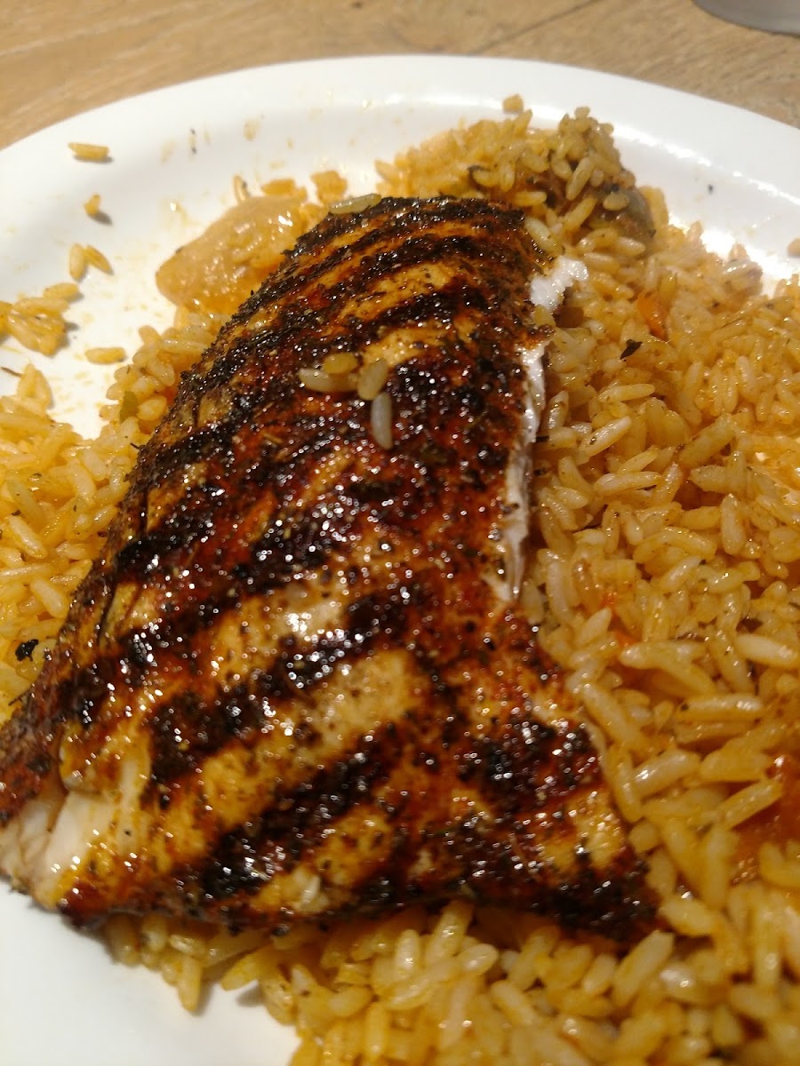 Grilled Mahi mahi on a bed of rice.This photo was taken after half of the fish and rice were eaten. Portion size was very generous. Delicious!