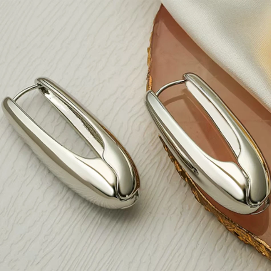 Brincos de pressão simples, ovais e brilhantes com gotas d'água, design geométrico elegante e sofisticado para qualquer ocasião.