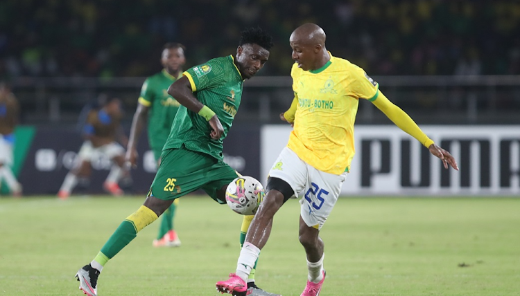 Mamelodi Sundowns' Khuliso Mudau and Kennedy Musonda of Young Africans compete for the ball in the 2023-24 Caf Champions League quarterfinal first leg match at Benjamin Mkapa Stadium in Dar-es-Salaam on Saturday night.