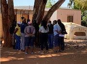 Police and IEC officials negotiate with community leaders at the Life Giving Ministries in Mamelodi East after residents tried to force their way into a voting station upon learning that their names were not on the voters' roll.