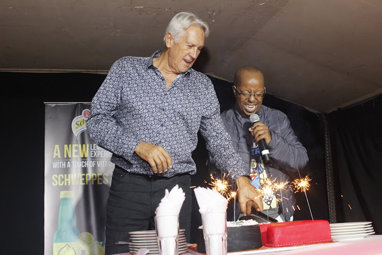 Tamarind Group chairman Martin Dunford assists birthday boy David Muriithi to cut his cake