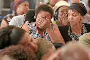 Family members become emotional as the admin officer of the Mamelodi Hospital Mortuary, Daniel Buda, describes the condition of a body during the  Life Esidimeni hearings in Parktown, Johannesburg. /photos  Alaister Russell
