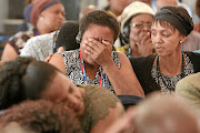 Family members become emotional as the admin officer of the Mamelodi Hospital Mortuary, Daniel Buda, describes the condition of a body during the  Life Esidimeni hearings in Parktown, Johannesburg.