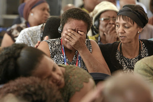 Family members become emotional as the admin officer of the Mamelodi Hospital Mortuary, Daniel Buda, describes the condition of a body during the Life Esidimeni hearings in Parktown, Johannesburg. /photos Alaister Russell