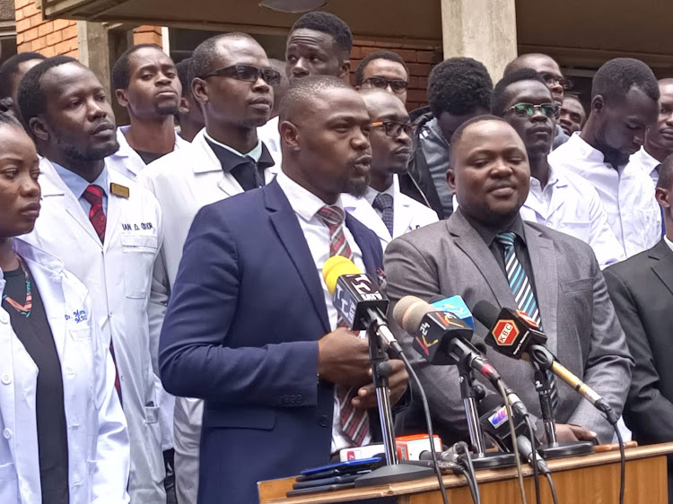 Medical interns flanked by Kenya Medical Practitioners Pharmacists and Dentists Union SG Dr Davji Atellah and Deputy SG Dr Miskellah Dennis during a media briefing in Nairobi on May 9, 2023.