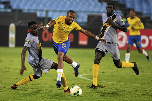 Tiyani Mabunda of Mamelodi Sundowns is tackled by Wonlo Coulibaly of Asec Mimosas./ Gallo Images / Lee Warren