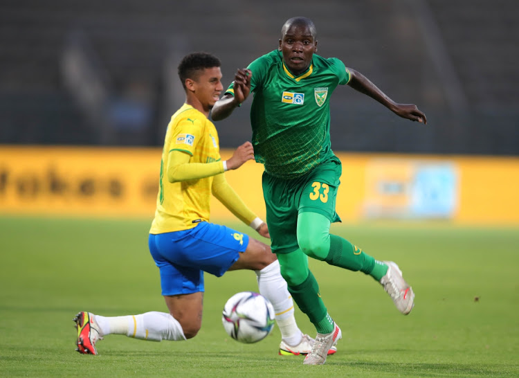 Michael Gumede of Golden Arrows tackled by Rushine De Reuck of Mamelodi Sundowns during the 2021 MTN8 semifinal 2nd leg match.