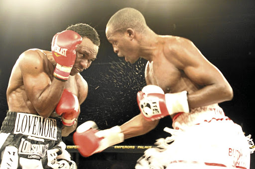 Philip Ndou throws an uppercut at Lovemore Ndou. Lovemore won the 12-round fight on a unanimous points decision to claim the IBO welterweight title at Emperors Palace in 2009. / BAFANA MAHLANGU