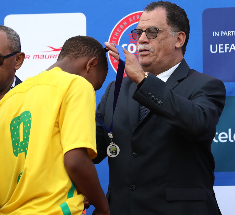 The SA Football Association (Safa) President Danny Jordaan hands out the losers' medals during the Cosafa Under 17 Youth Championships Final match between South Africa and Angola at the Francois Xavier Stadium in Port Louis, Mauritius on July 29 2018.