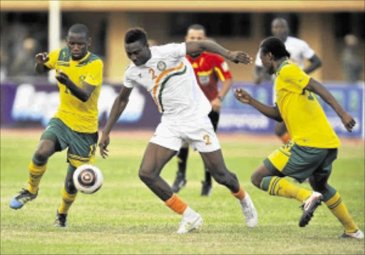 SINK OR SWIM? Bafana Bafana defenders Thanduyise Khuboni, left, and Siyabonga Sangweni vie for the ball with Niger striker Maazou Moussa during their Africa Cup of Nations in Niamey last month. Bafana will play against Sierra Leone and Niger take on Egypt tomorrow. Photo: Gallo Images