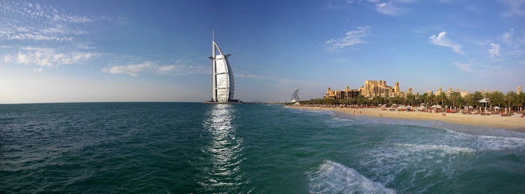 Beachfront hotels run up to the distinctive Burj Al Arab hotel in Dubai.