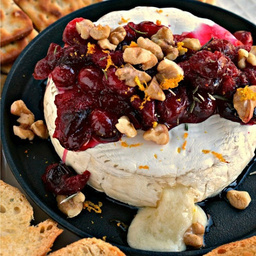 Baked Brie is always a hit when entertaining.  This winning combination of cranberries, walnuts, rosemary and honey is easy, elegant and flavorful.  Bake some today and impress your friends and family.