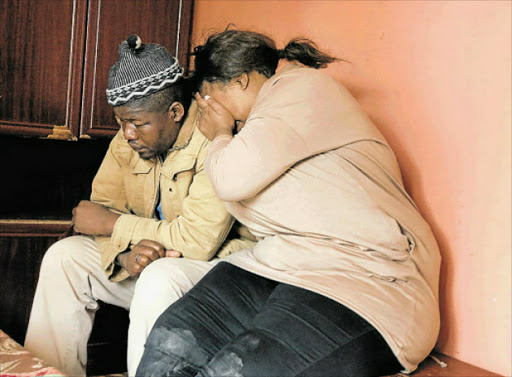 DEVASTATED: Lilitha Mnyanda's aunt Vuyokazi Siboyana and her father, Zolani Siboyana , weep as Vuyokazi recounts how the three children were killed in the accident at the weekend. Picture: ZWANGA MUKHUTHU