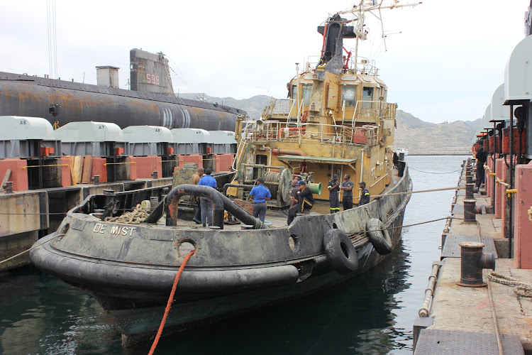 The tug De Mist in the synchrolift at Simon's Town naval dockyard after being lifted from the seabed in a complex salvage operation