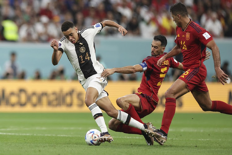 Jamal Musiala (L) of Germany breaks through during the Group E match against Spain at the 2022 FIFA World Cup at Al Bayt Stadium in Al Khor, Qatar on Nov. 27, 2022.