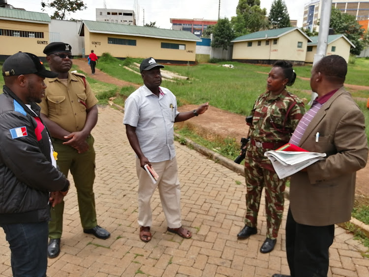 National athletics coach Julius Kirwa with AK Nyanza South chairman Peter Angwenyi at Gusii Stadium