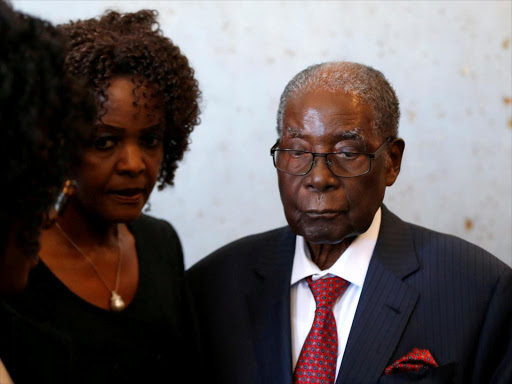 Zimbabwe's former president Robert Mugabe and his wife Grace look on before voting in the general elections in Harare, Zimbabwe, July 30, 2018. /REUTERS