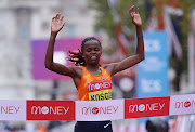 Kenya's Brigid Kosgei celebrates as she wins the elite women's race of the London Marathon.