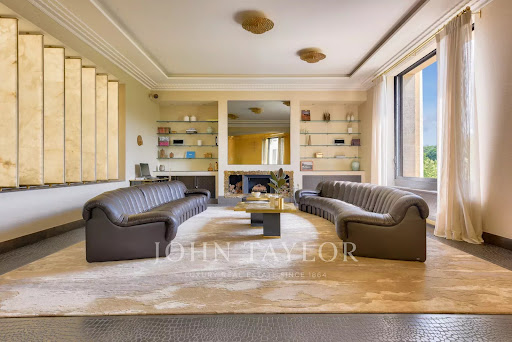 living room with two curved sofas in this luxury apartment / penthouse for sale in Paris 16ème ($14,708,397 - 425 m²)