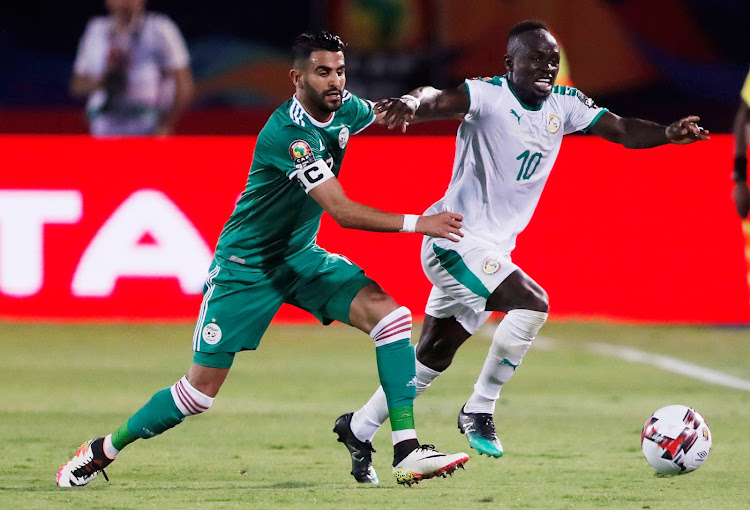 Senegal's Sadio Mane in action with Algeria's Riyad Mahrez