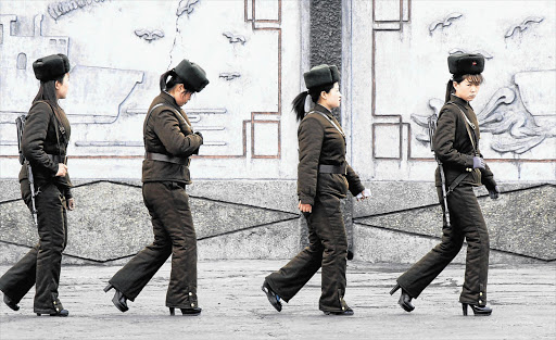 Female North Korean soldiers patrol along the banks of the Yalu River yesterday. South Korea and the US were on high alert ahead of a North Korean missile launch