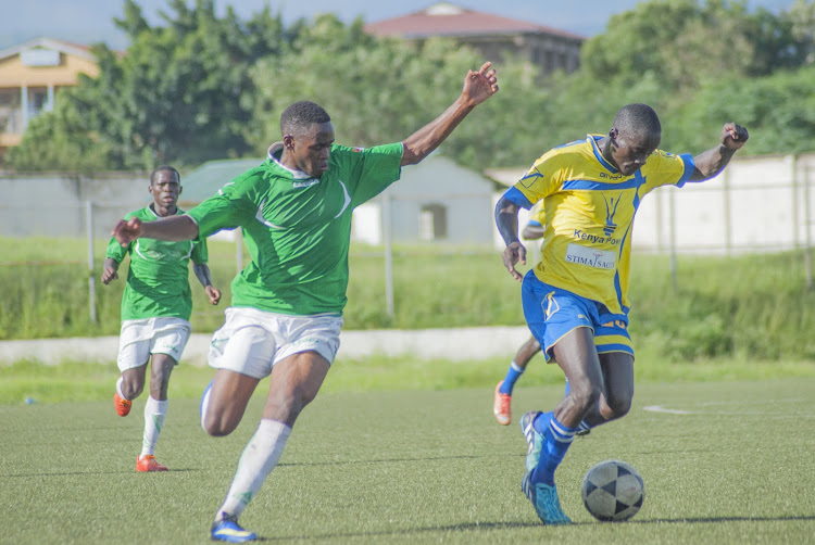 Western Stima's Geoffrey Ochieng (R) dribbles past Green Commando's Griffins Amatala in a past match