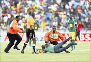 MADNESS: A fan who tried to attack the referee with a vuvuzela  is brought down during the  match between Golden Arrows and Kaizer Chiefs at Moses Mabhida Stadium in Durban. PHOTO:  Gallo Images