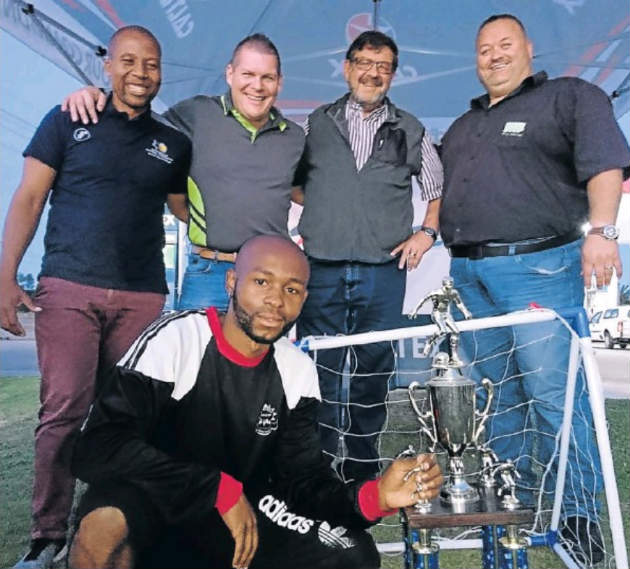 Young Ideas player Thando Oyisi (front) hopes to retain the Caltex Greenbushes Fresh Stop Youth Day soccer tournament title next week. With him are (back, from left) Kuyga LFA member Xola Peter, Robert Engelbrecht, of Fresh Stop, and Jurie Snyman and Dewald Niemand, from Caltex Greenbushes