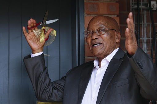 President Zuma cuts the ribbon on a housing project in Pietermaritzburg on Saturday morning.