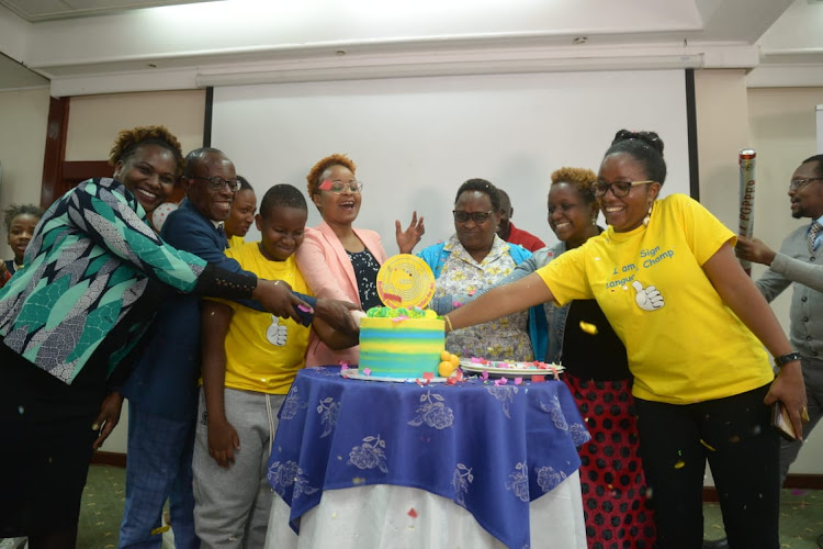 The CEO and Founder of Lugha Ishara Nancy Maina (in pink) leads parents in marking the International Week of Deaf People in Nairobi on September 22, 2022