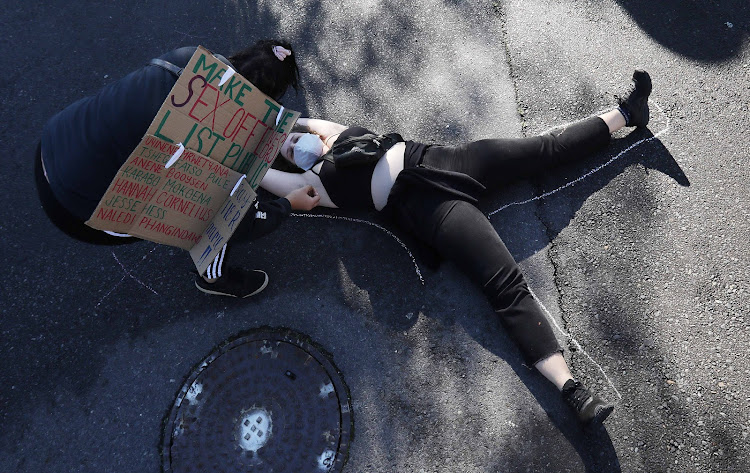 Protesters lay on a road and observed five minutes of silence for victims of gender-based violence.