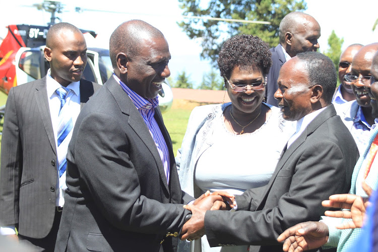 Deputy President William Ruto (left) greets residents when he arrived at Kabartonjo in Baringo North Sub-county for AIC church fundraiser on Saturday.