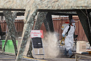 Staff wearing a protective suit disinfects a COVID-19 testing site at the Hsinchu science park, following an increasing number of locally transmitted coronavirus disease cases, in Hsinchu, Taiwan, June 8 2021. 