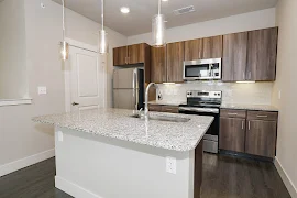 Kitchen featuring stainless steel appliances, granite countertops, and wood cabinets
