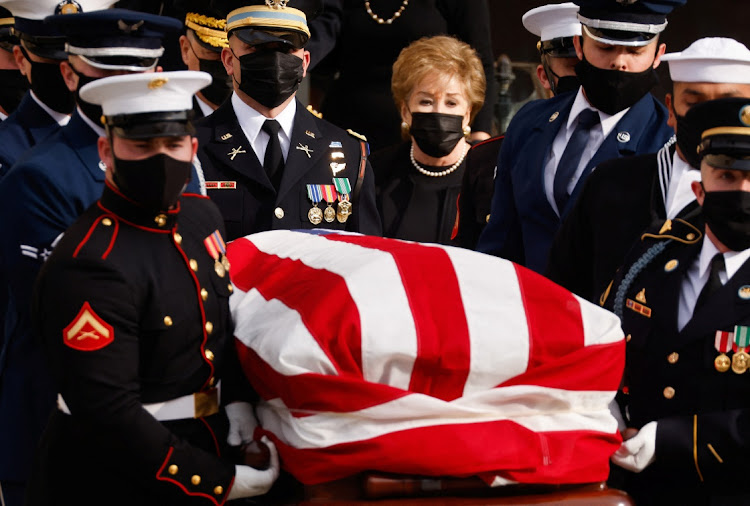 US former Senator Elizabeth Dole (R-NC), a widow of late Senate Majority Leader Bob Dole, walks behind Military Honor Guard members carrying his flag-draped casket following the funeral service at the National Cathedral in Washington, US, December 10, 2021.